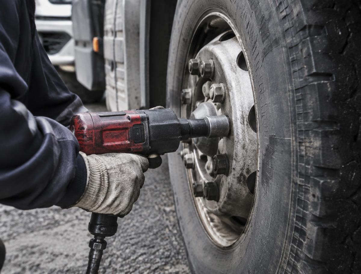 EMTS technician servicing a truck tire